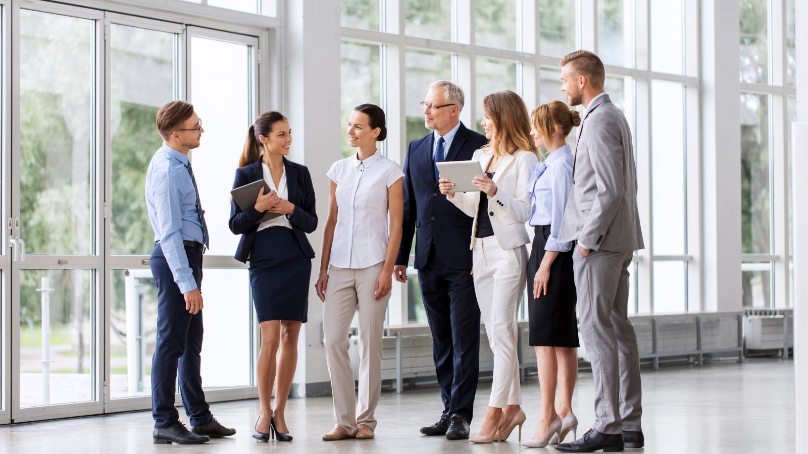 people, technology and corporate concept - business team with tablet pc computers at office